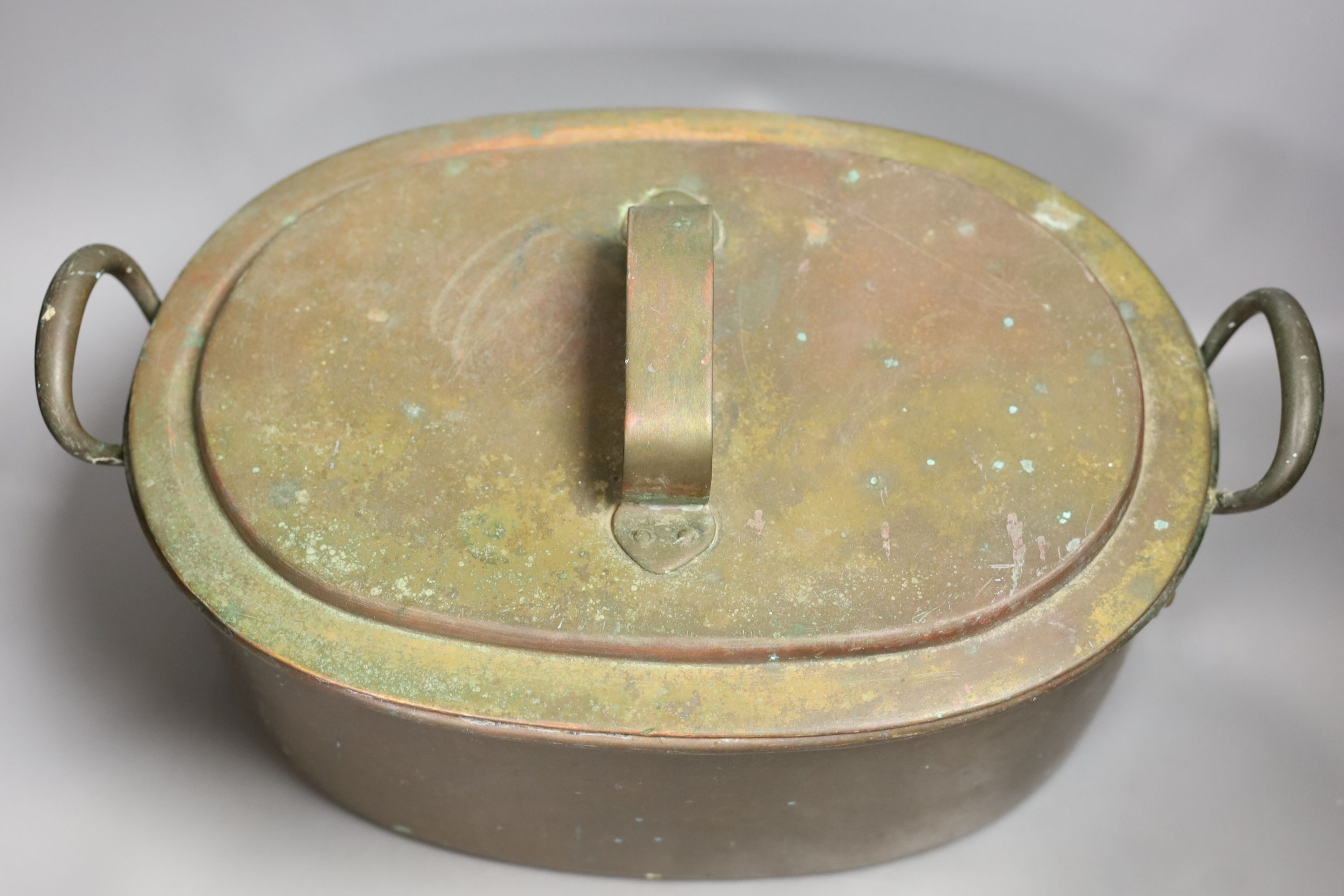 A Victorian oval copper two handled preserve pan and cover., 35cms wide.